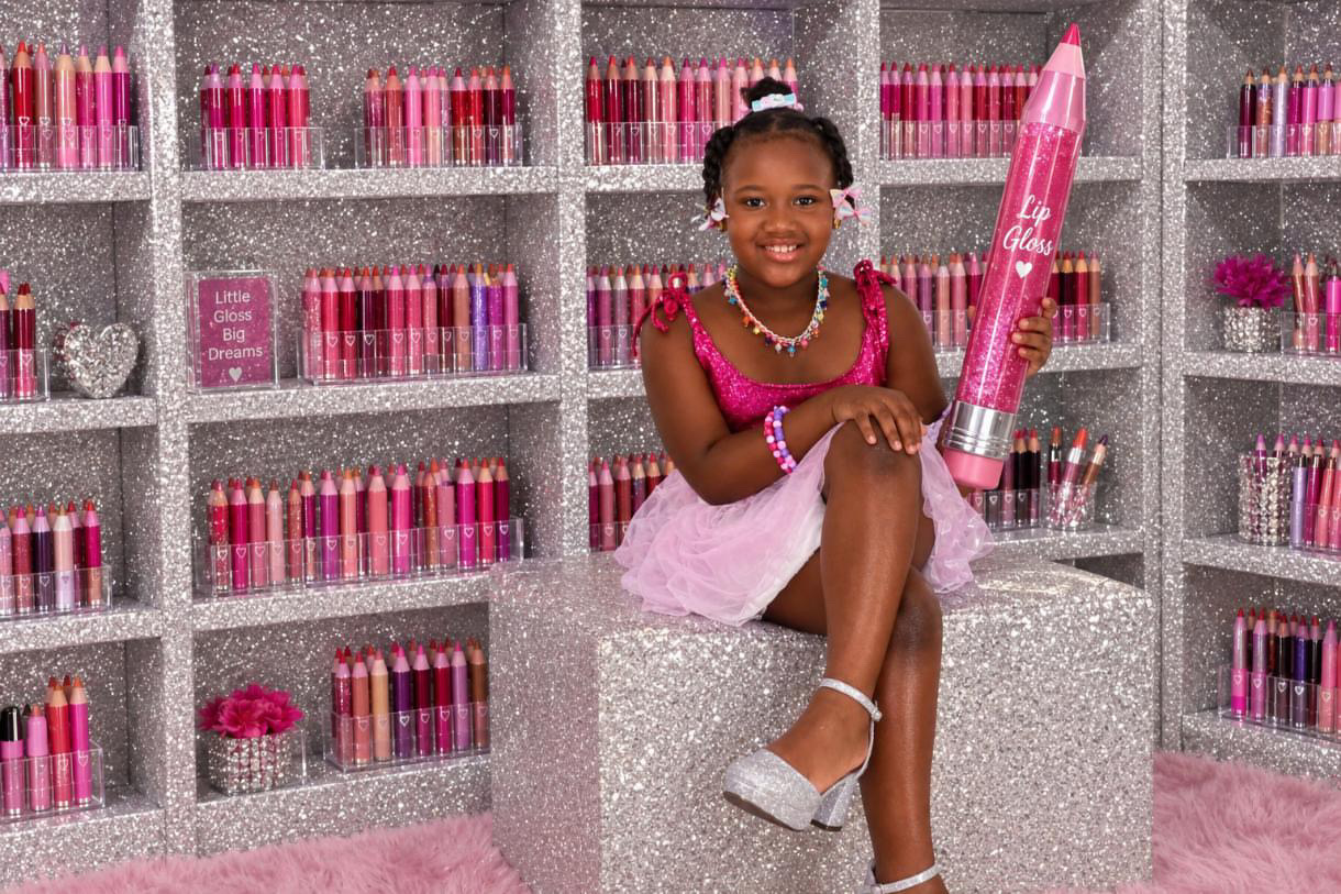 Zoey smiling in her gloss shop